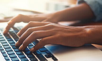 Closeup of laptop keyboard hands